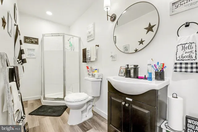 a bathroom with a sink a toilet and a mirror