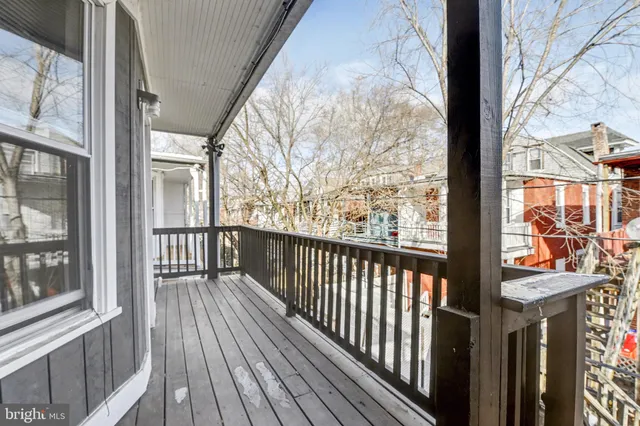 a view of a balcony with wooden floor and fence