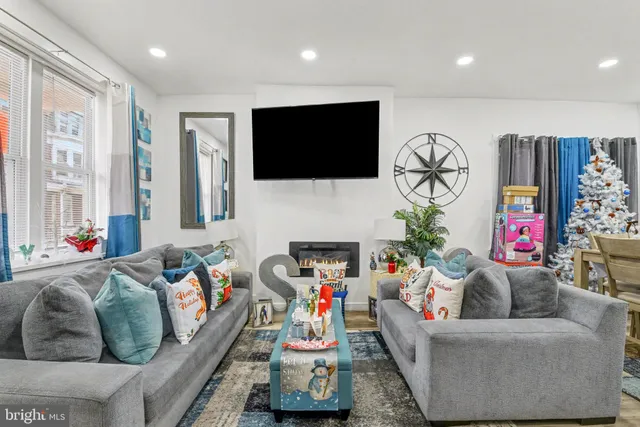 a living room with furniture and a flat screen tv