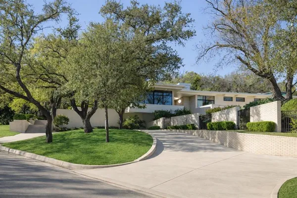 a front view of a house with a garden