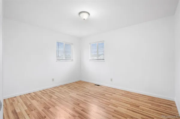 a view of a room with wooden floor and white walls