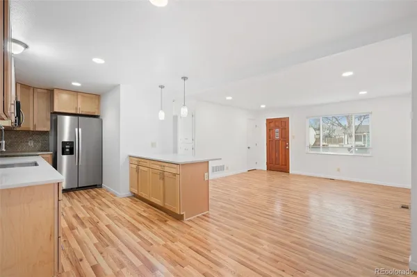 a large kitchen with kitchen island a sink stainless steel appliances and cabinets