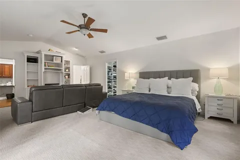 a bedroom with a bed and ceiling fan