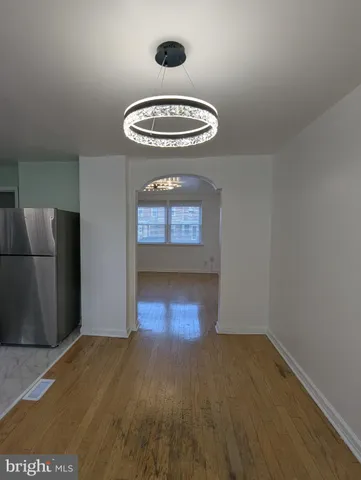 a room with a wooden floor and a window