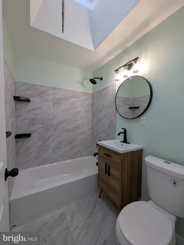 a bathroom with a toilet a sink and bathtub