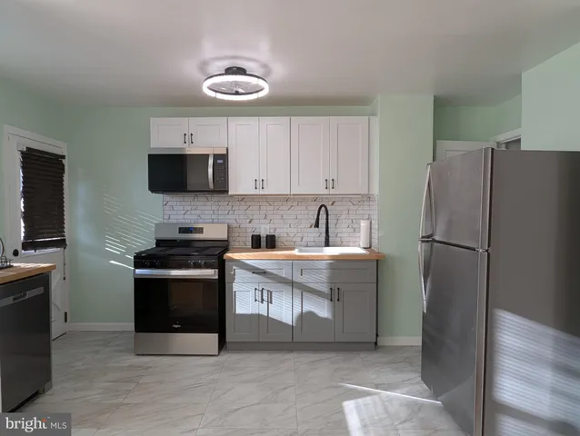 a kitchen with a refrigerator stove and microwave