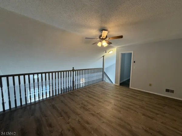 a view of a room with wooden floor