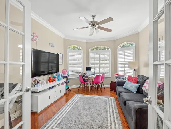 a bedroom with a bed and a large window