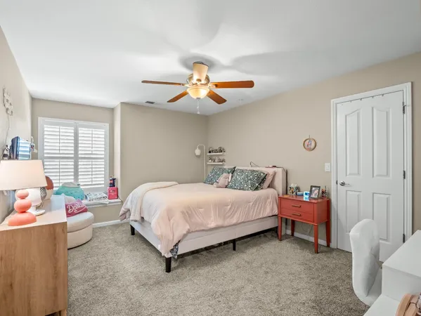 a spacious bedroom with a bed and a chandelier