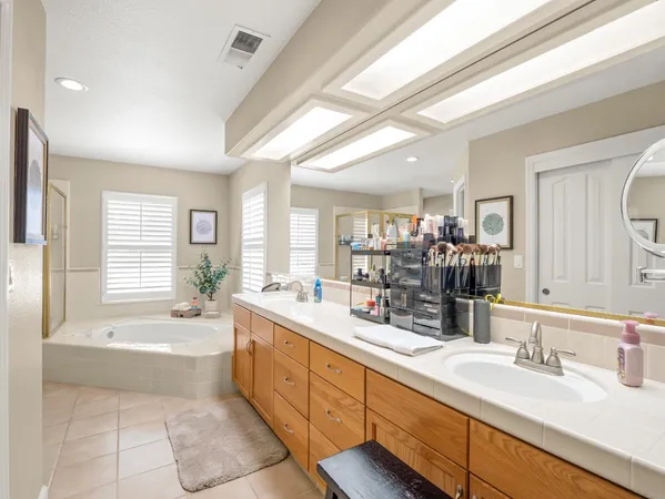 a bathroom with a granite countertop sink a toilet and shower