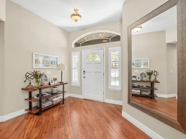 a view of a room with wooden floor and furniture