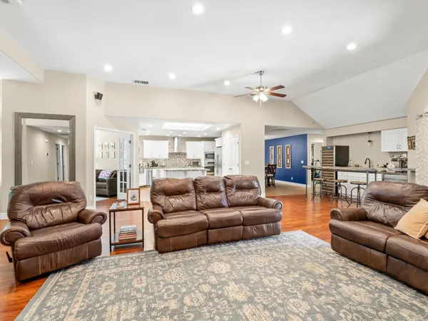 a living room with furniture and kitchen view