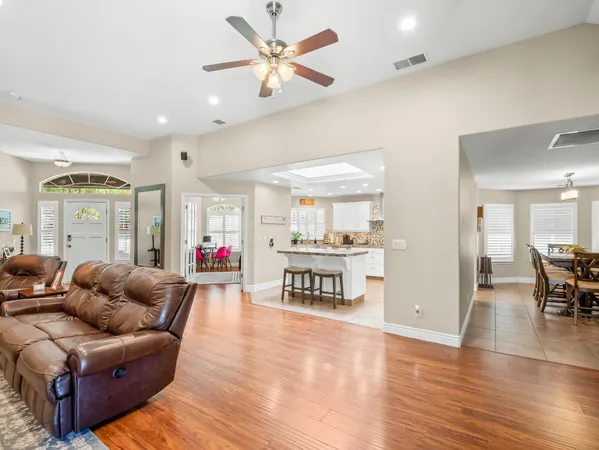 a living room with furniture and a kitchen view