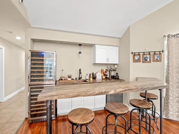 a kitchen with a table chairs stove and cabinets