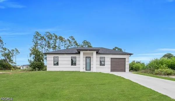 a view of a house with a backyard