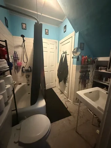a bathroom with a sink mirror vanity and toilet