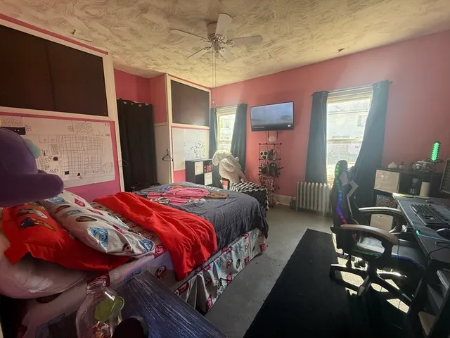 a bedroom with a bed and a chair