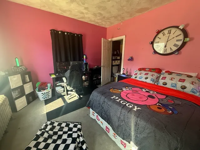 a bed sitting in a bedroom next to a window