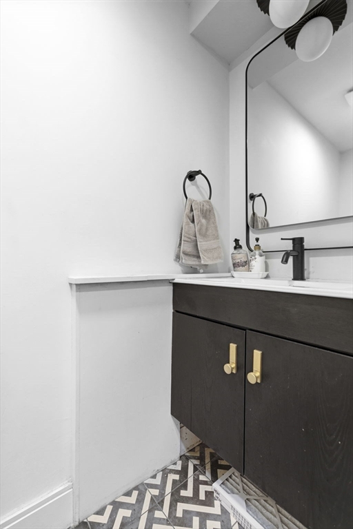 92 Chelsea Street, Unit 1 Boston, MA 02128 - Photo 10 of 14 a bathroom with a sink and a mirror
