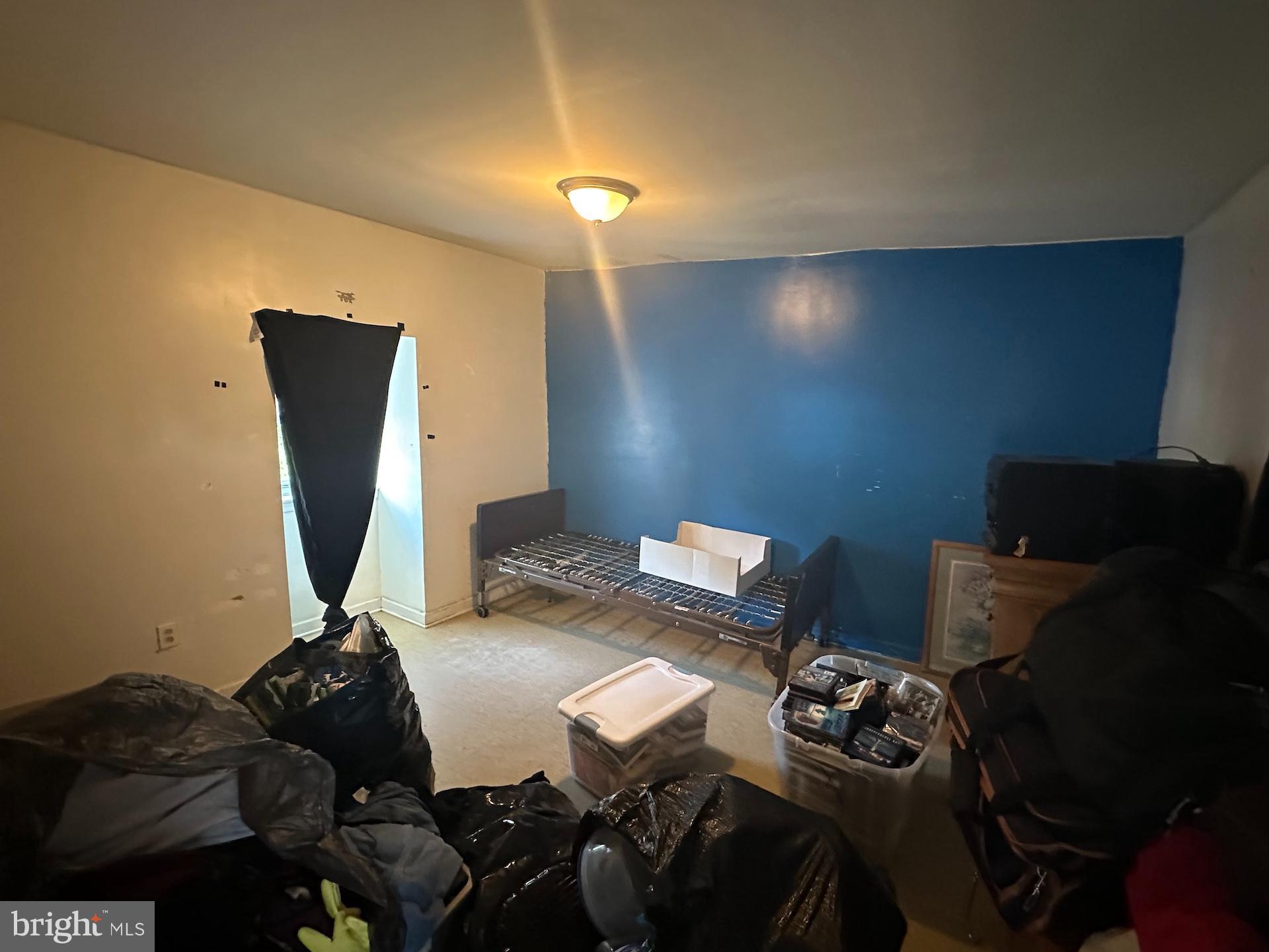 3926 Ridgewood Avenue Baltimore, MD 21215 - Photo 9 of 21 Spacious bedroom #1 with vibrant blue accent wall.