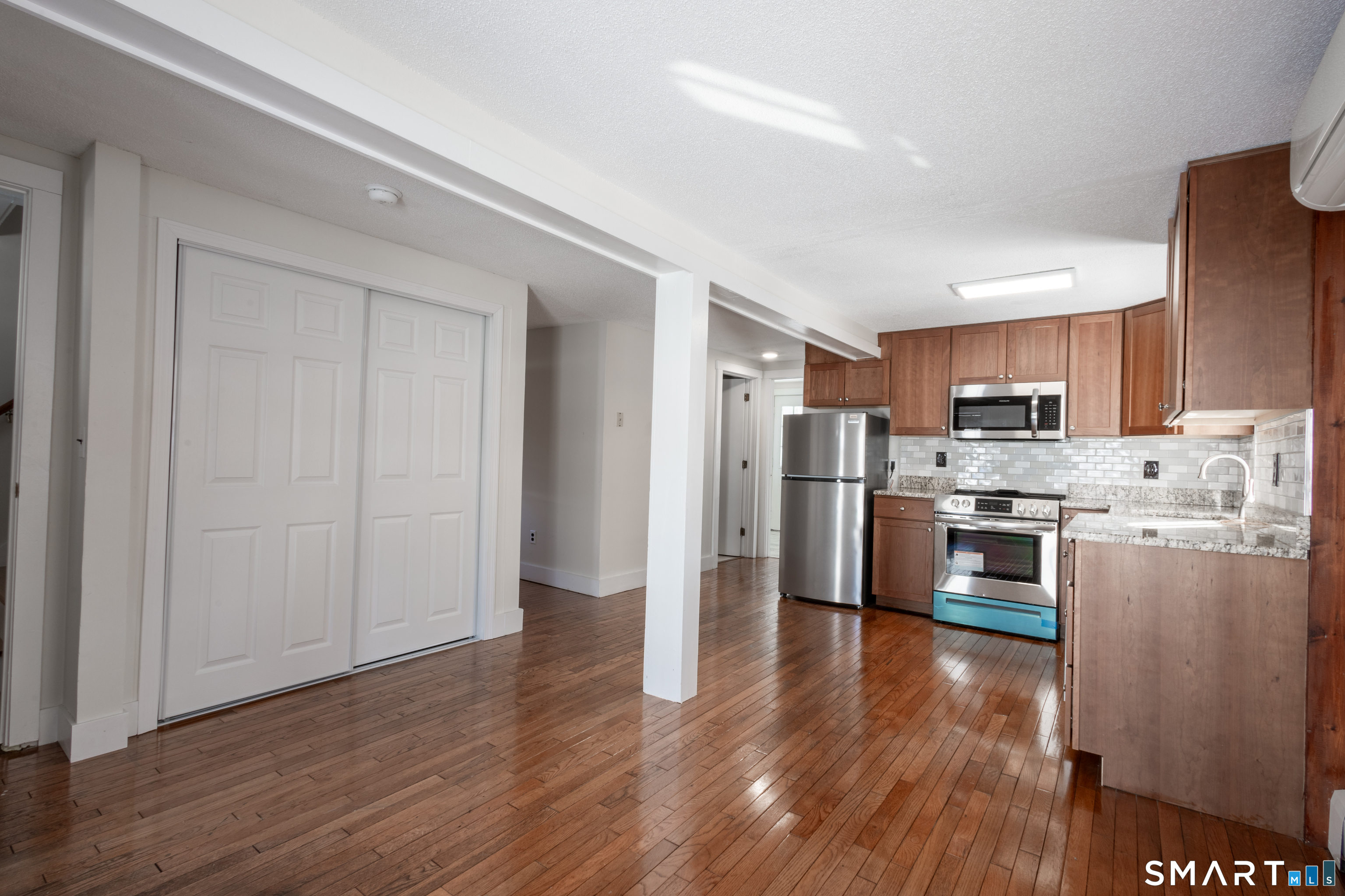 89 Hempstead Street New London, CT 06320 - Photo 2 of 14 a kitchen with stainless steel appliances granite countertop a refrigerator and a stove top oven