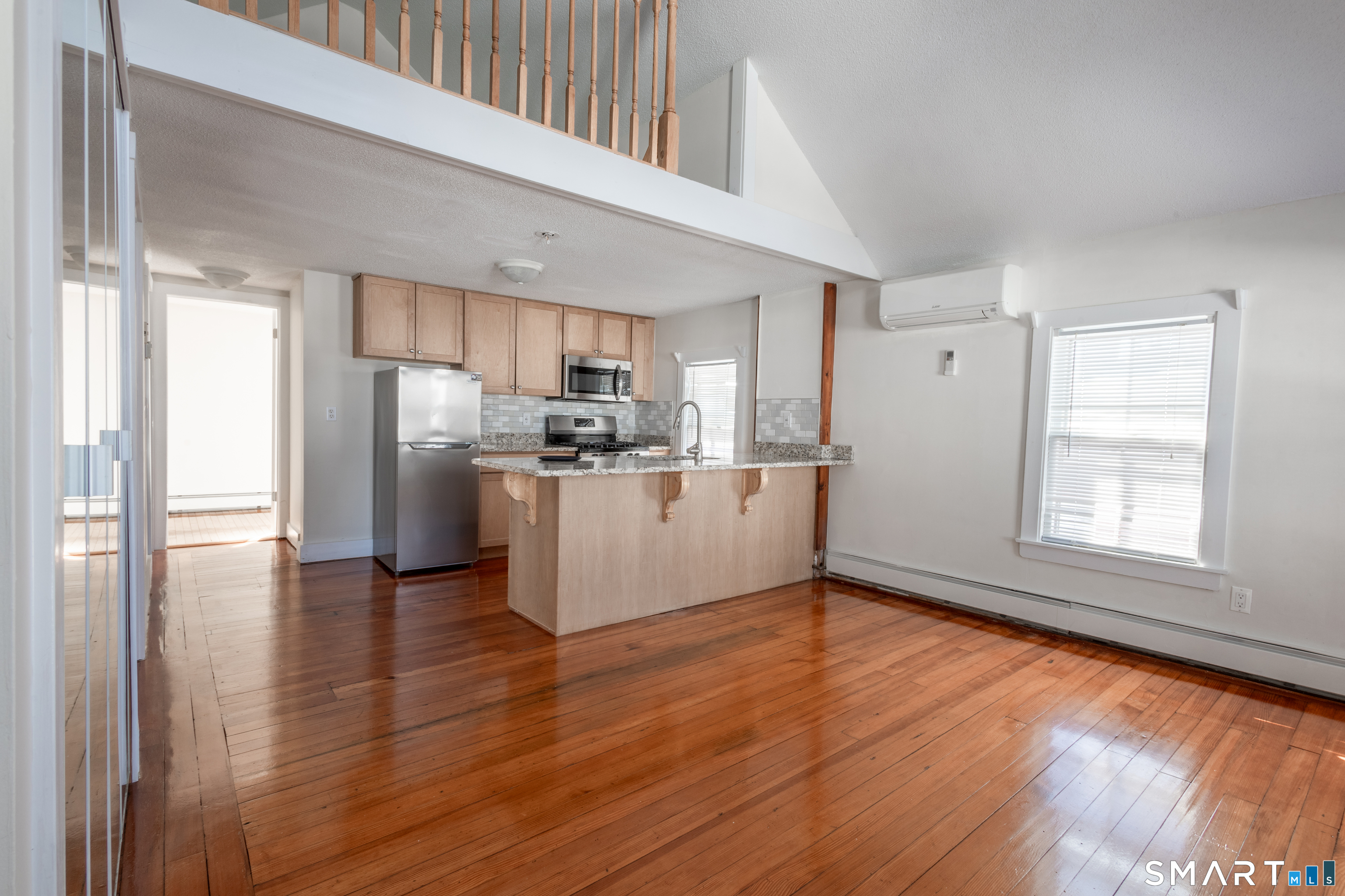 89 Hempstead Street New London, CT 06320 - Photo 4 of 14 a view of a kitchen with wooden floor electronic appliances and window