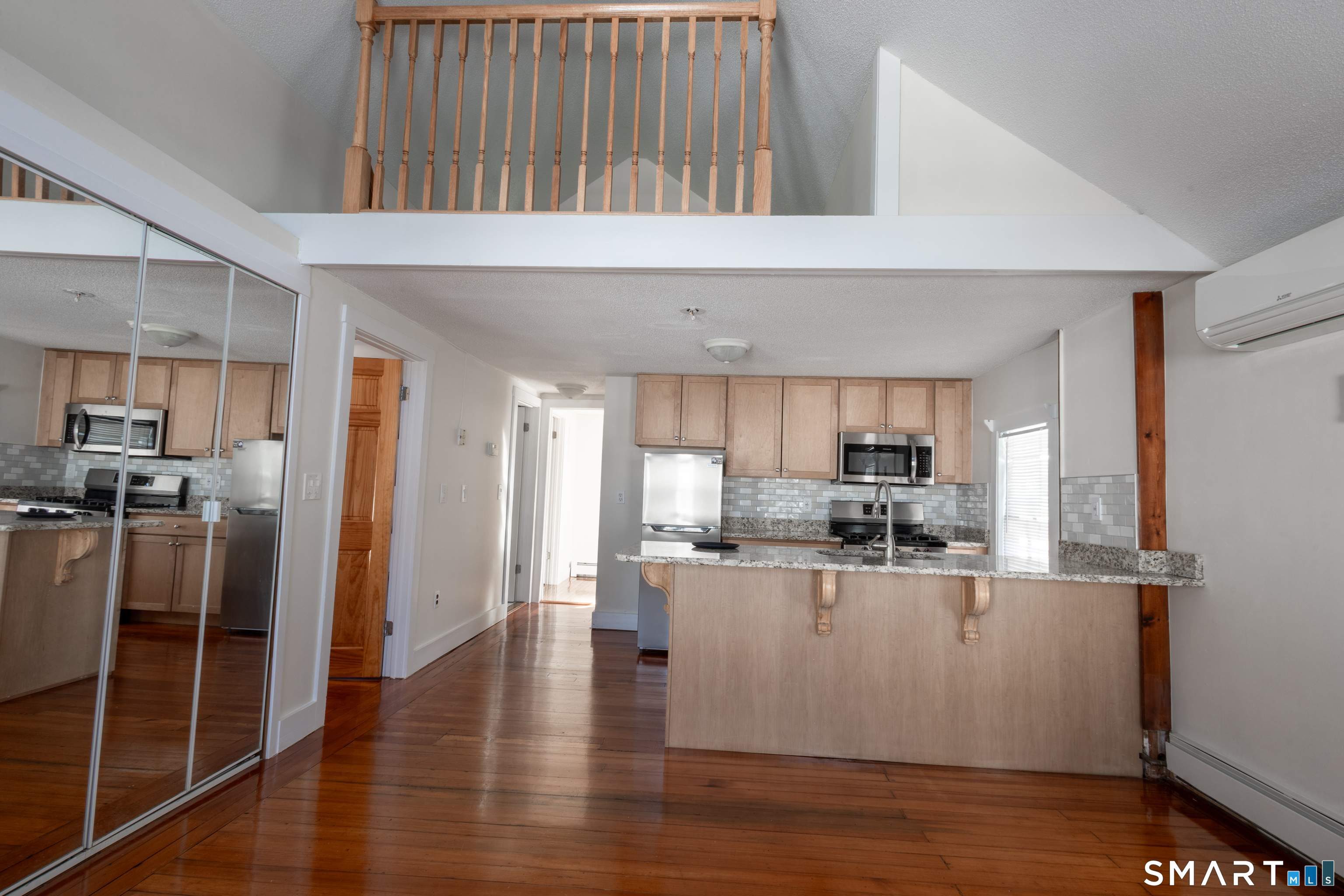 89 Hempstead Street New London, CT 06320 - Photo 5 of 14 a kitchen with stainless steel appliances granite countertop a refrigerator a sink dishwasher a stove and white countertops with wooden floor
