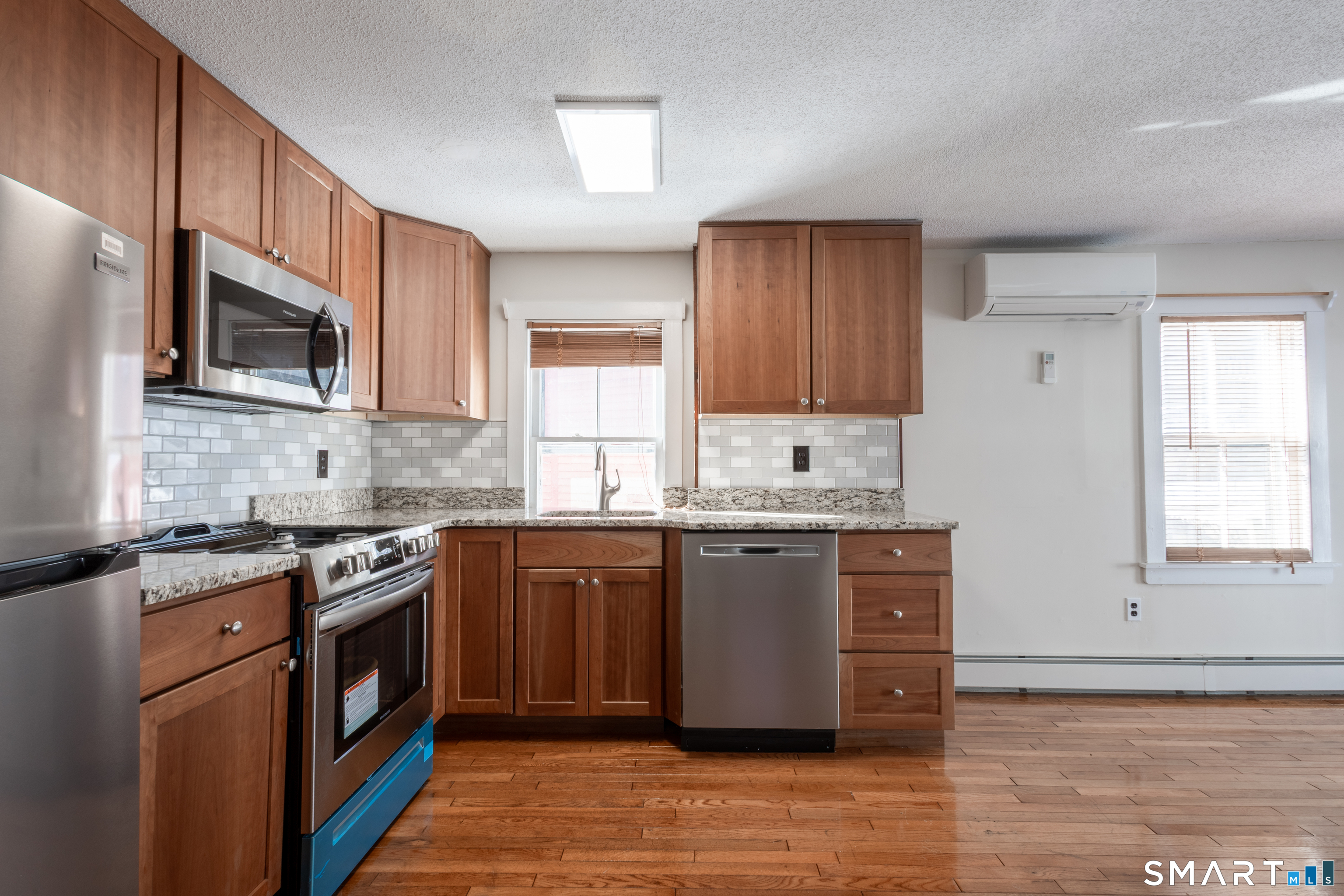 89 Hempstead Street New London, CT 06320 - Photo 6 of 14 a kitchen with stainless steel appliances granite countertop wooden cabinets a stove top oven a sink and dishwasher