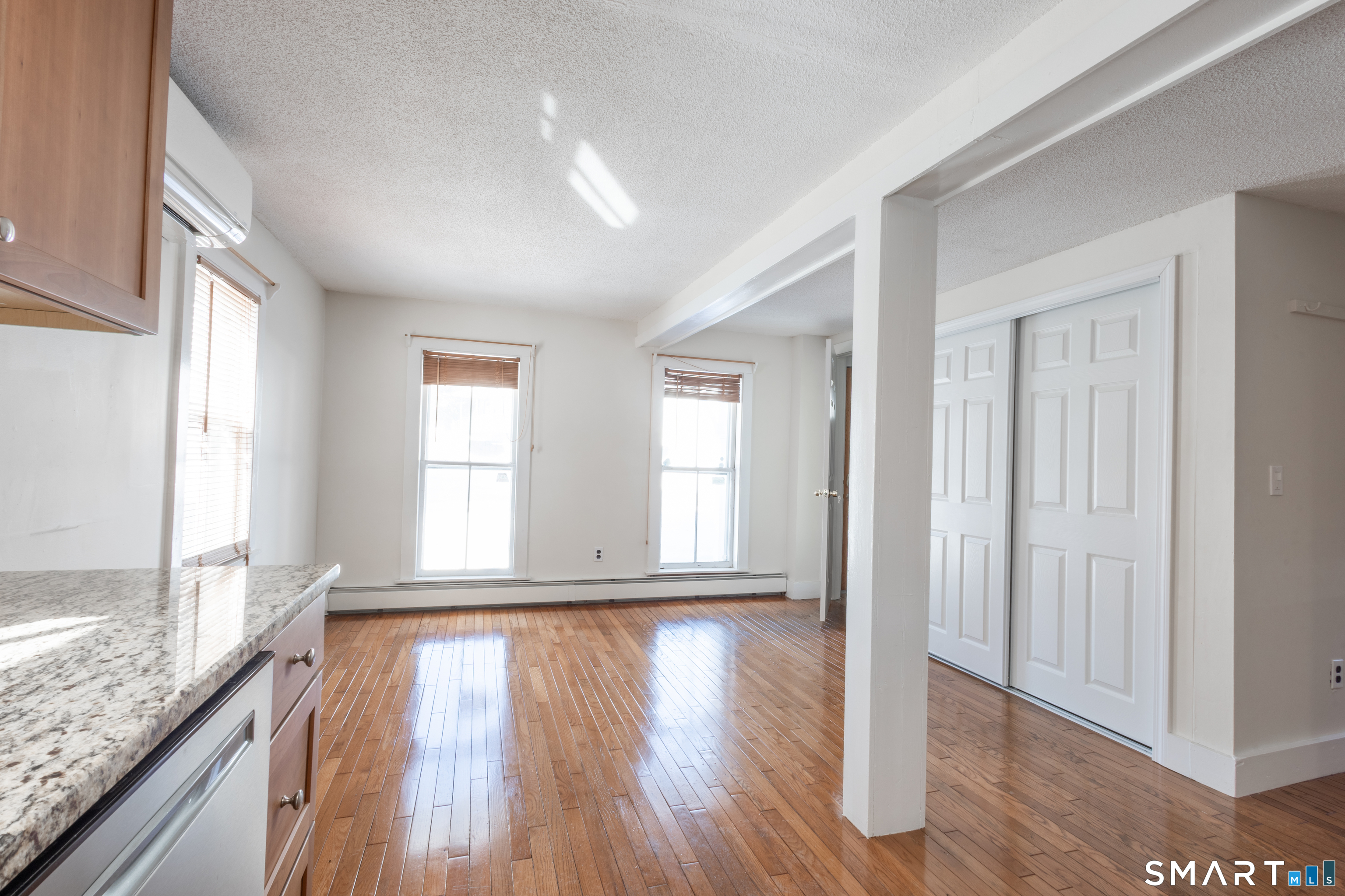 89 Hempstead Street New London, CT 06320 - Photo 7 of 14 wooden floor in an empty room with a window