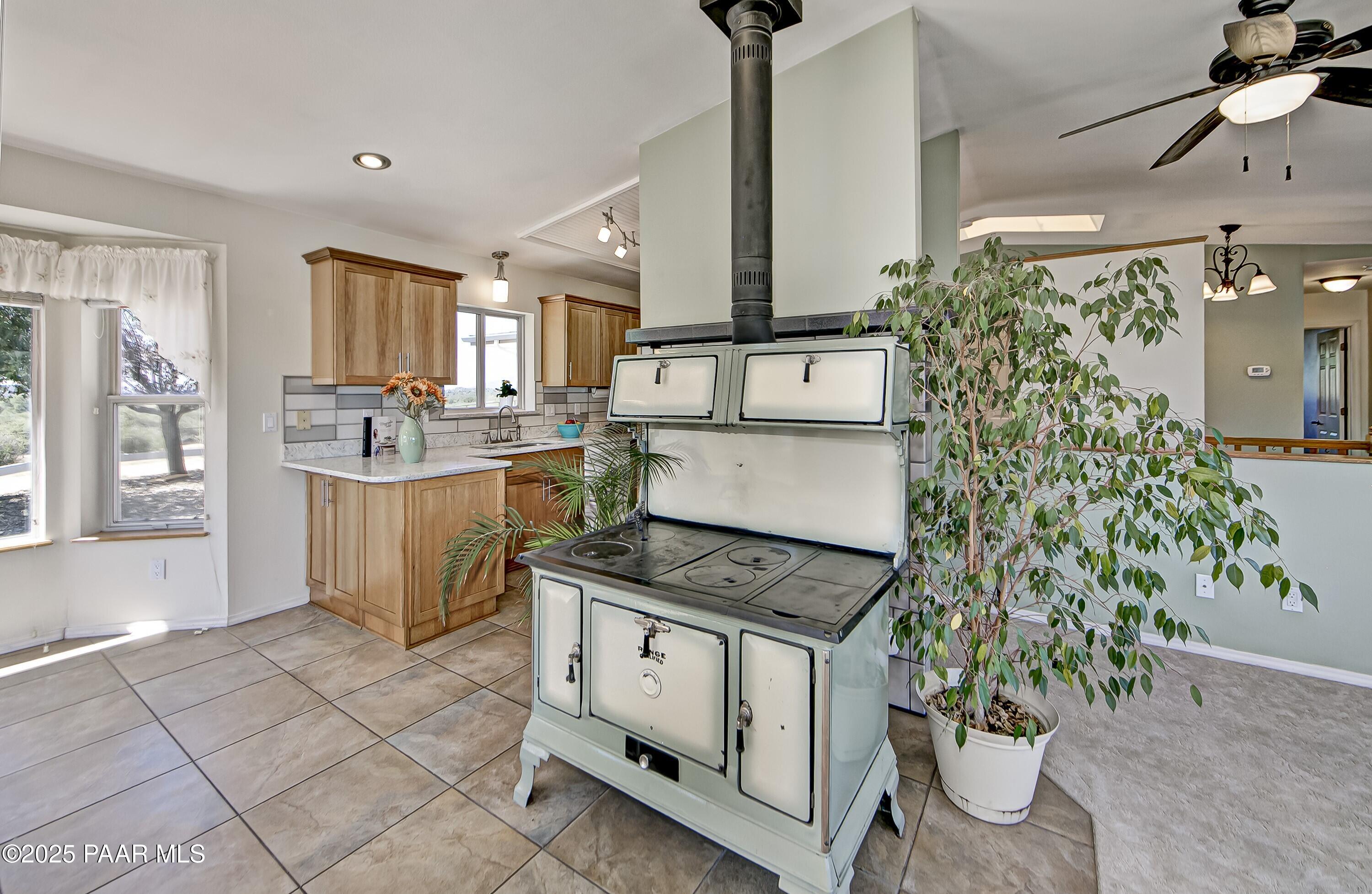 11800 West Faded Whistle Road Prescott, AZ 86305 - Photo 16 of 65 a kitchen that has a lot of white cabinets and stainless steel appliances