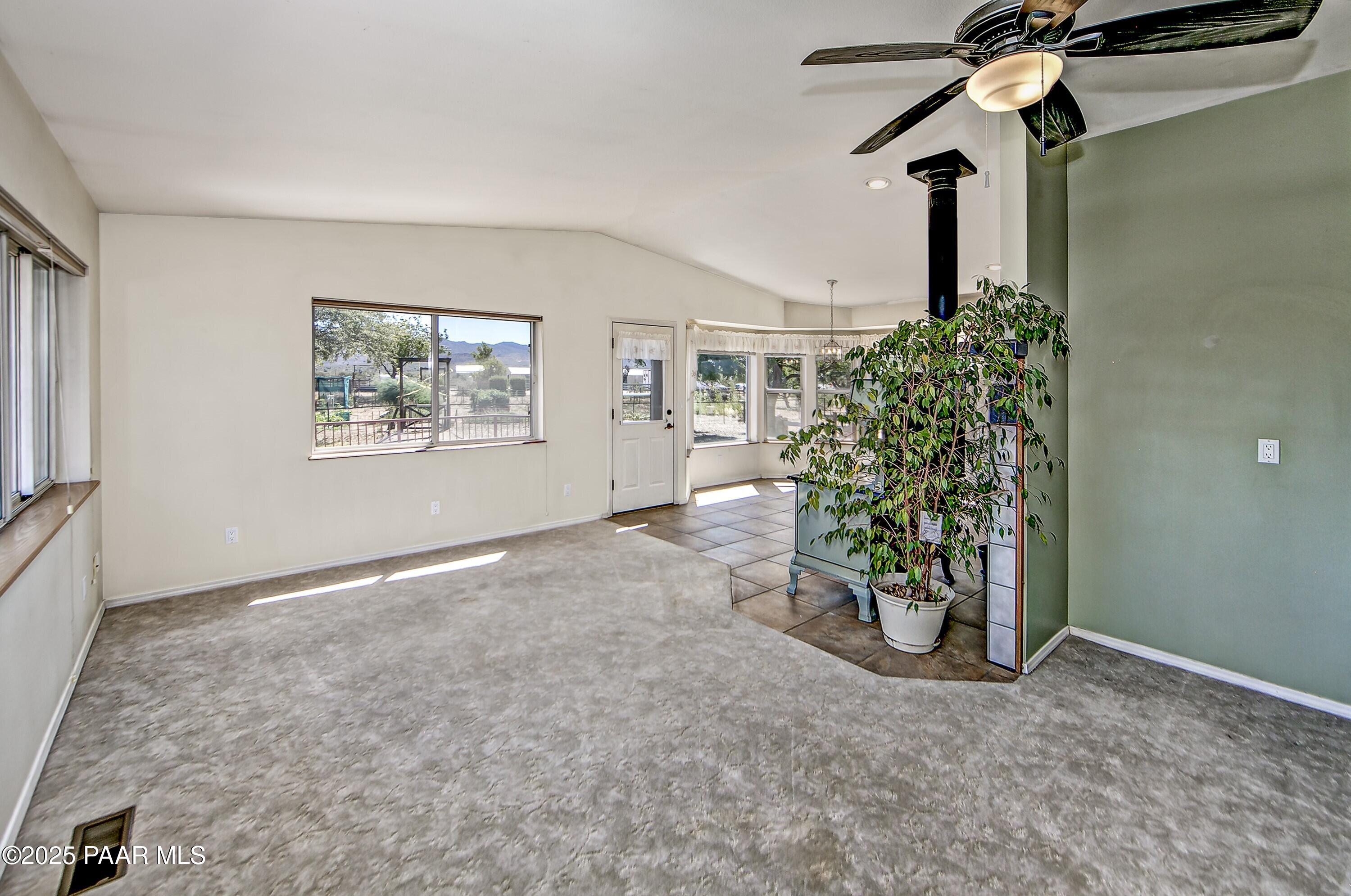11800 West Faded Whistle Road Prescott, AZ 86305 - Photo 20 of 65 an empty room with windows and ceiling fan