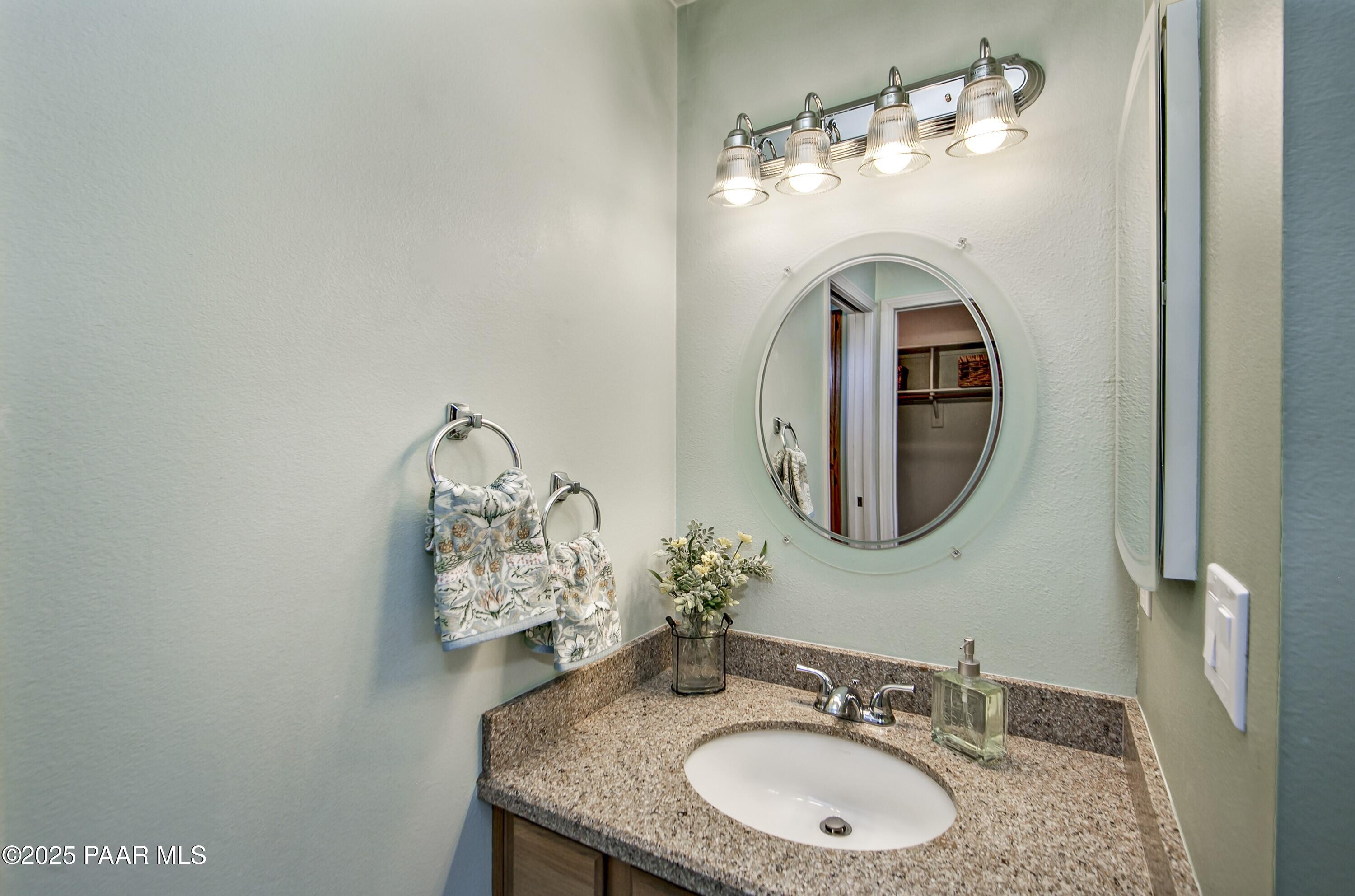 11800 West Faded Whistle Road Prescott, AZ 86305 - Photo 26 of 65 a bathroom with a sink and a mirror
