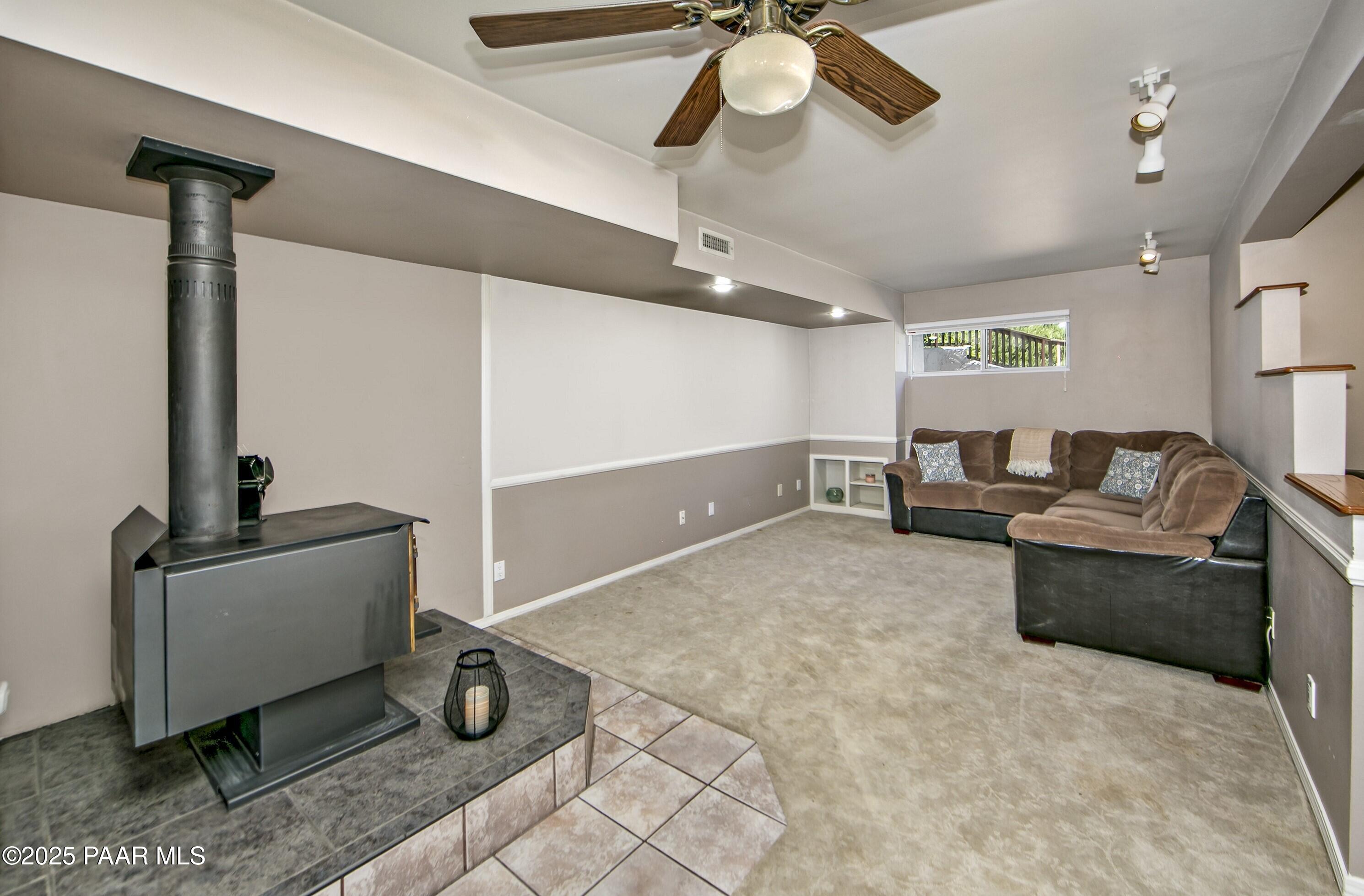 11800 West Faded Whistle Road Prescott, AZ 86305 - Photo 35 of 65 a living room with furniture and a chandelier