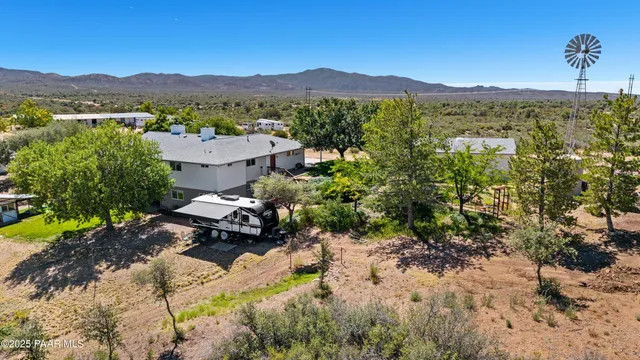 a kitchen that has a lot of white cabinets and stainless steel appliances