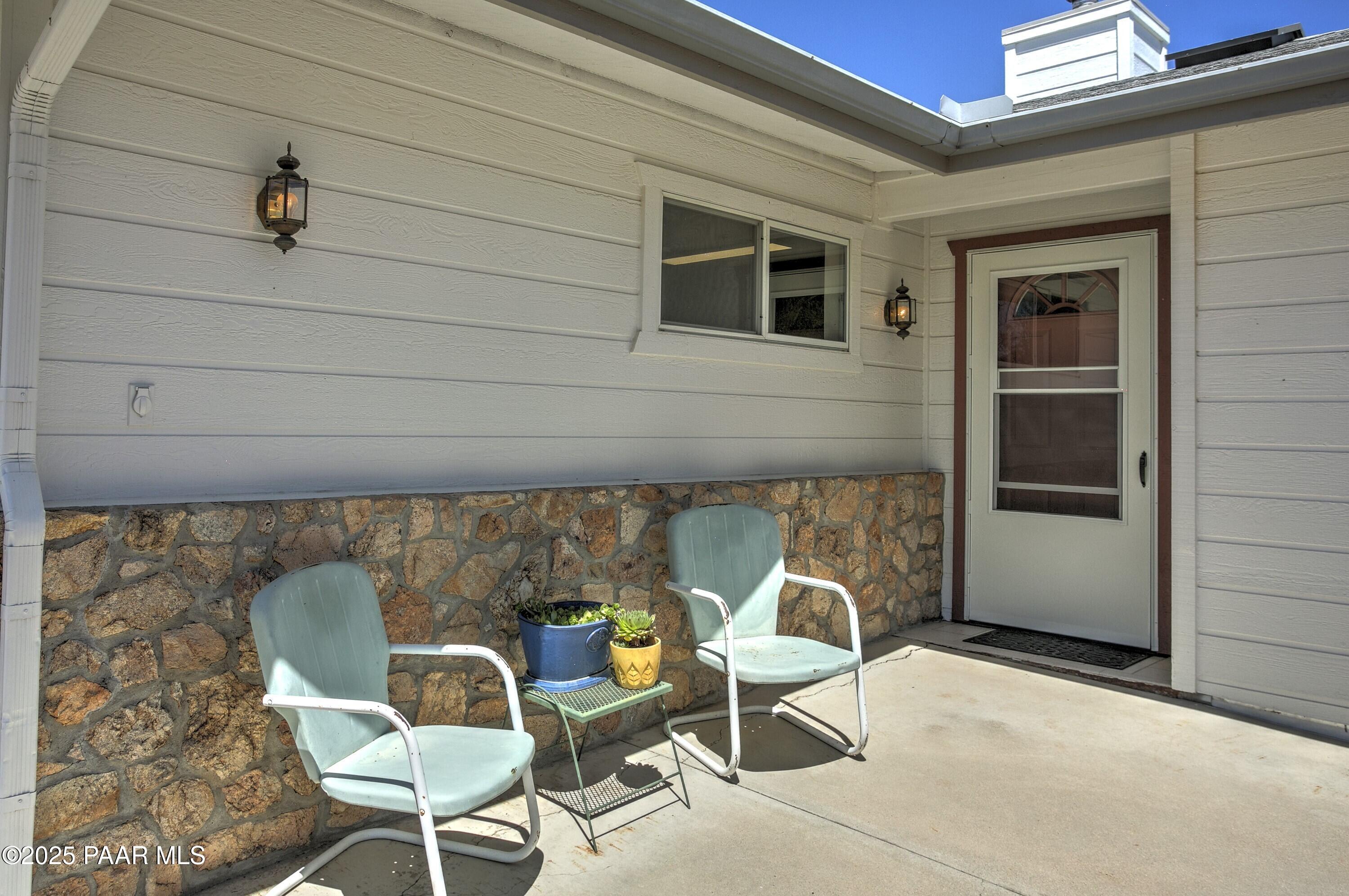 11800 West Faded Whistle Road Prescott, AZ 86305 - Photo 65 of 65 a couple of chairs sitting in front of a door