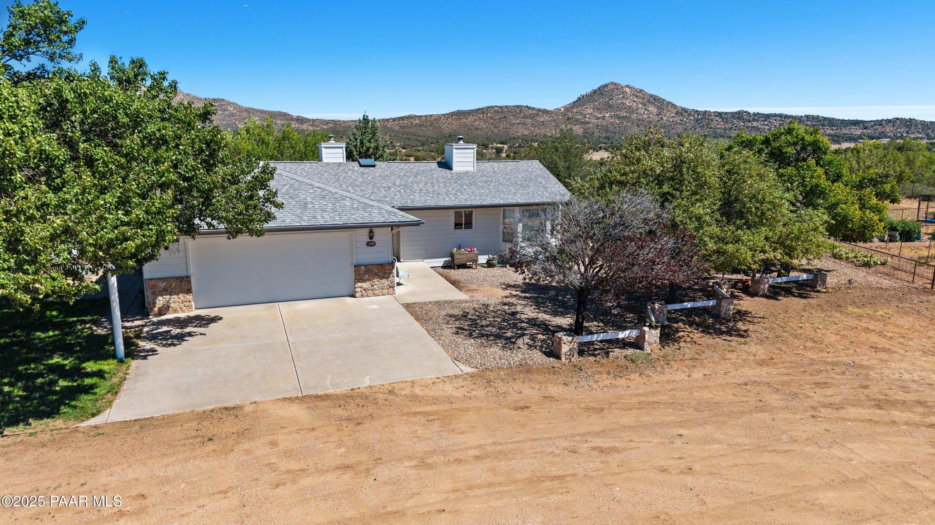 11800 West Faded Whistle Road Prescott, AZ 86305 - Photo 7 of 65 a view of a patio with a table and chairs under an umbrella