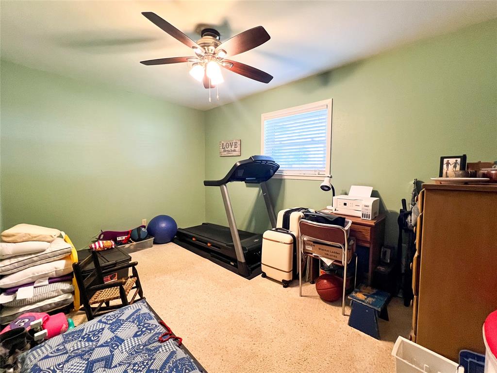 1009 North 7th Street Haskell, TX 79521 - Photo 14 of 26 a bed room with a bed and a chandelier