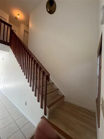 a bathroom with a granite countertop sink toilet and mirror