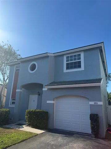 a front view of a house with garage