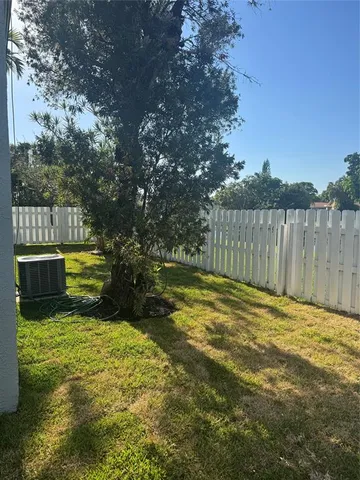 a view of a yard with wooden fence