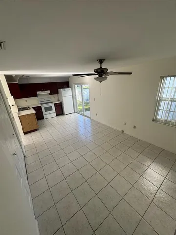 an empty room with white walls and tiles