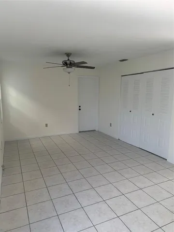 a large kitchen with a stove top oven and cabinets