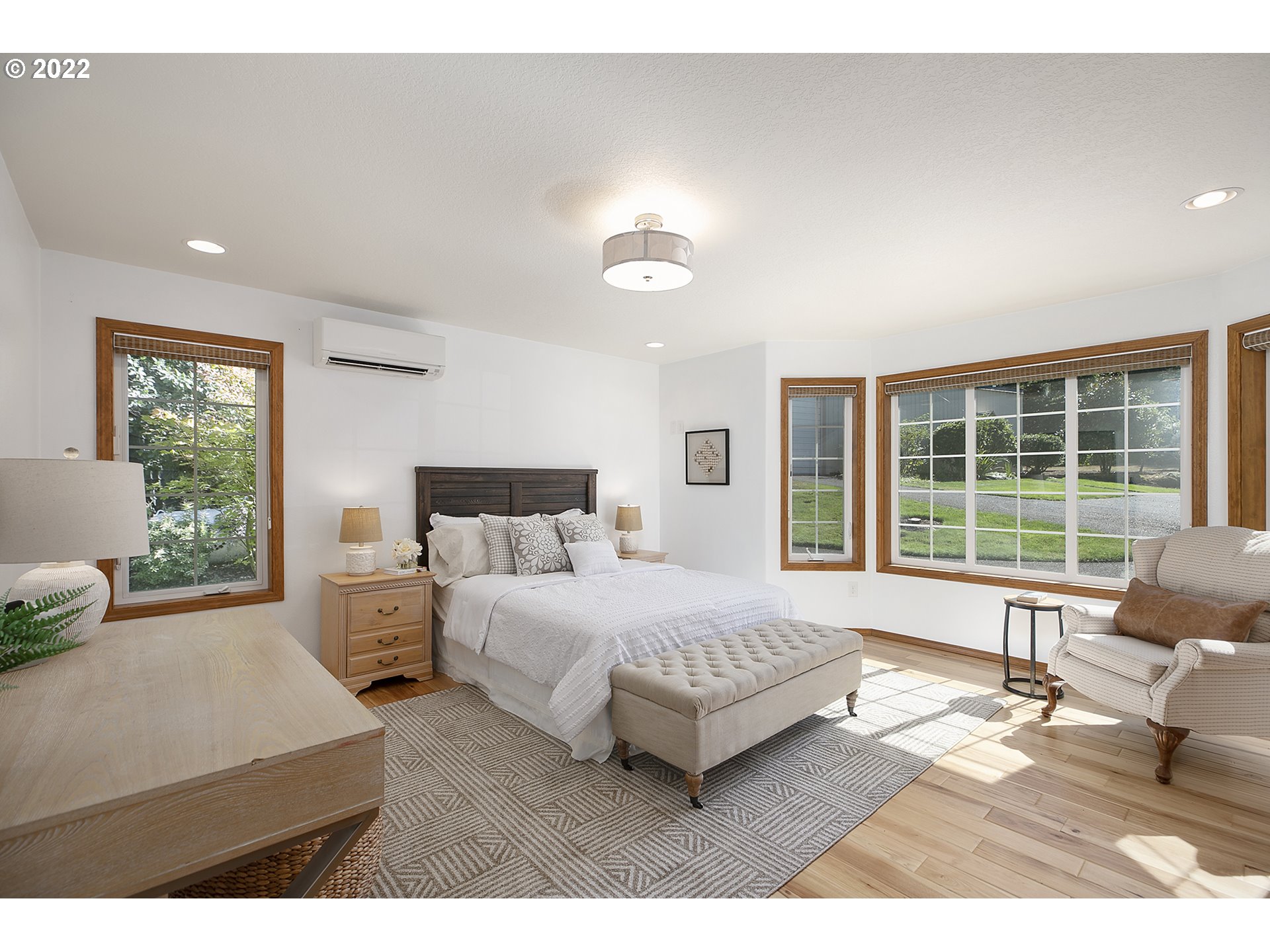 43221 Southeast Coalman Road Sandy, OR 97055 - Photo 17 of 32 a spacious bedroom with a large bed and a large window