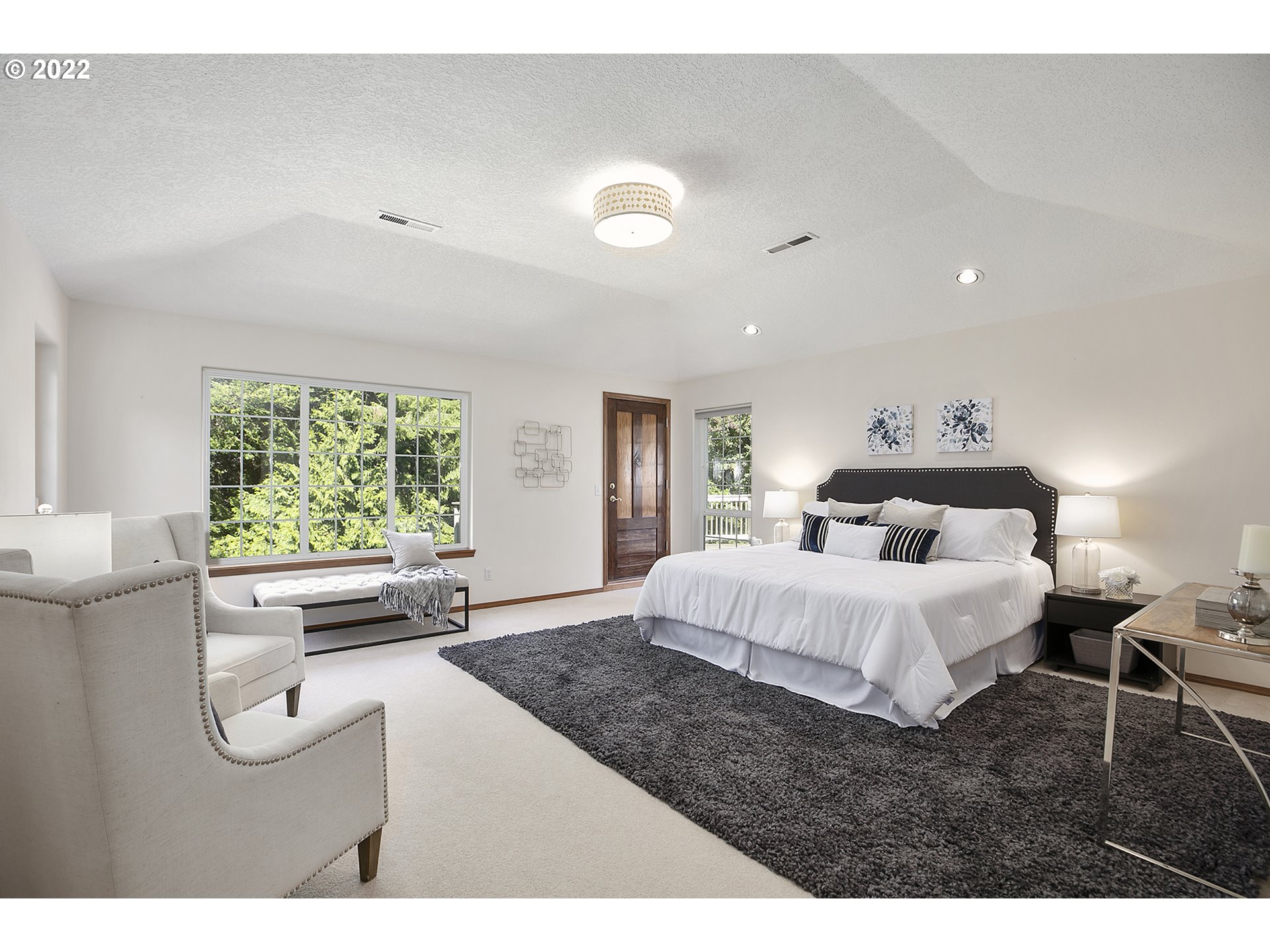 43221 Southeast Coalman Road Sandy, OR 97055 - Photo 20 of 32 a spacious bedroom with a bed and a large window