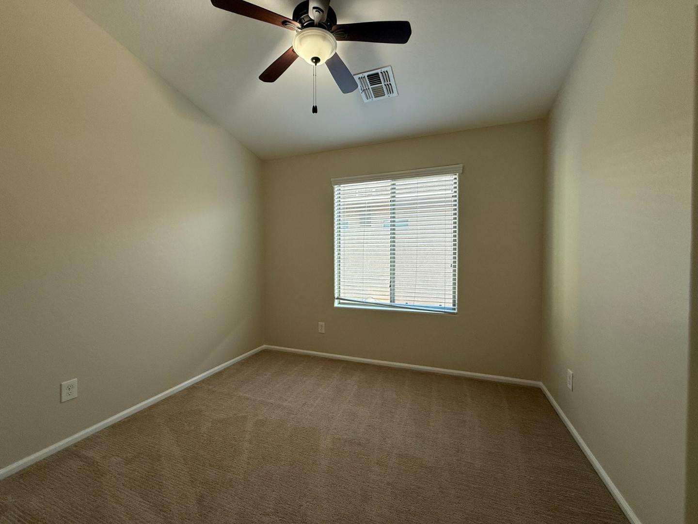 2725 East Mine Creek Road, Unit 1151 Phoenix, AZ 85024 - Photo 21 of 31 an empty room with a window and a fan