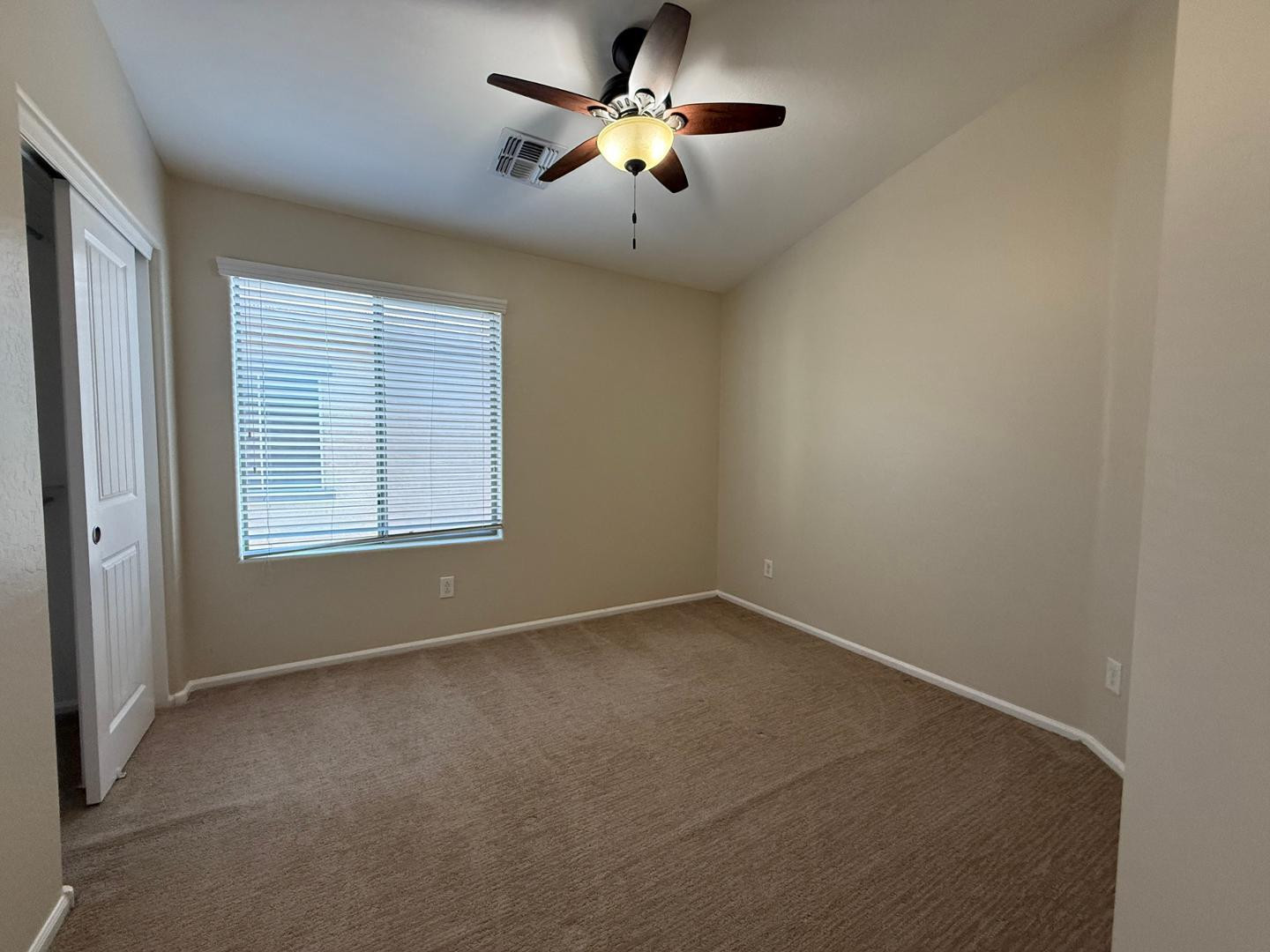 2725 East Mine Creek Road, Unit 1151 Phoenix, AZ 85024 - Photo 24 of 31 an empty room with a window and a ceiling fan