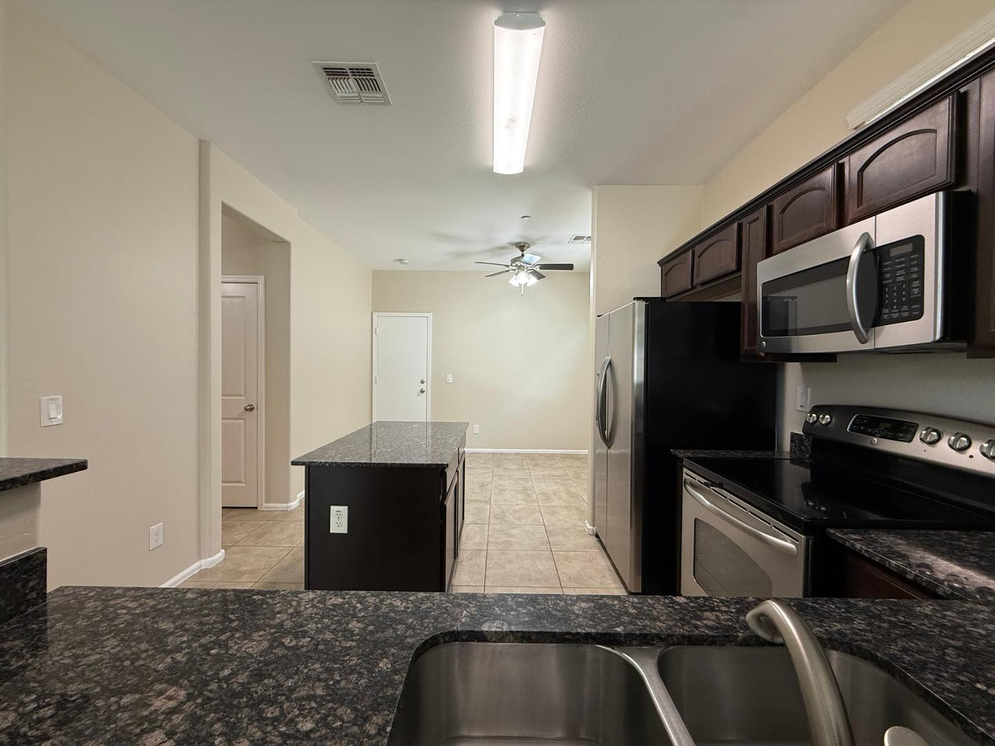 2725 East Mine Creek Road, Unit 1151 Phoenix, AZ 85024 - Photo 3 of 31 a kitchen with stainless steel appliances granite countertop a refrigerator and a stove top oven