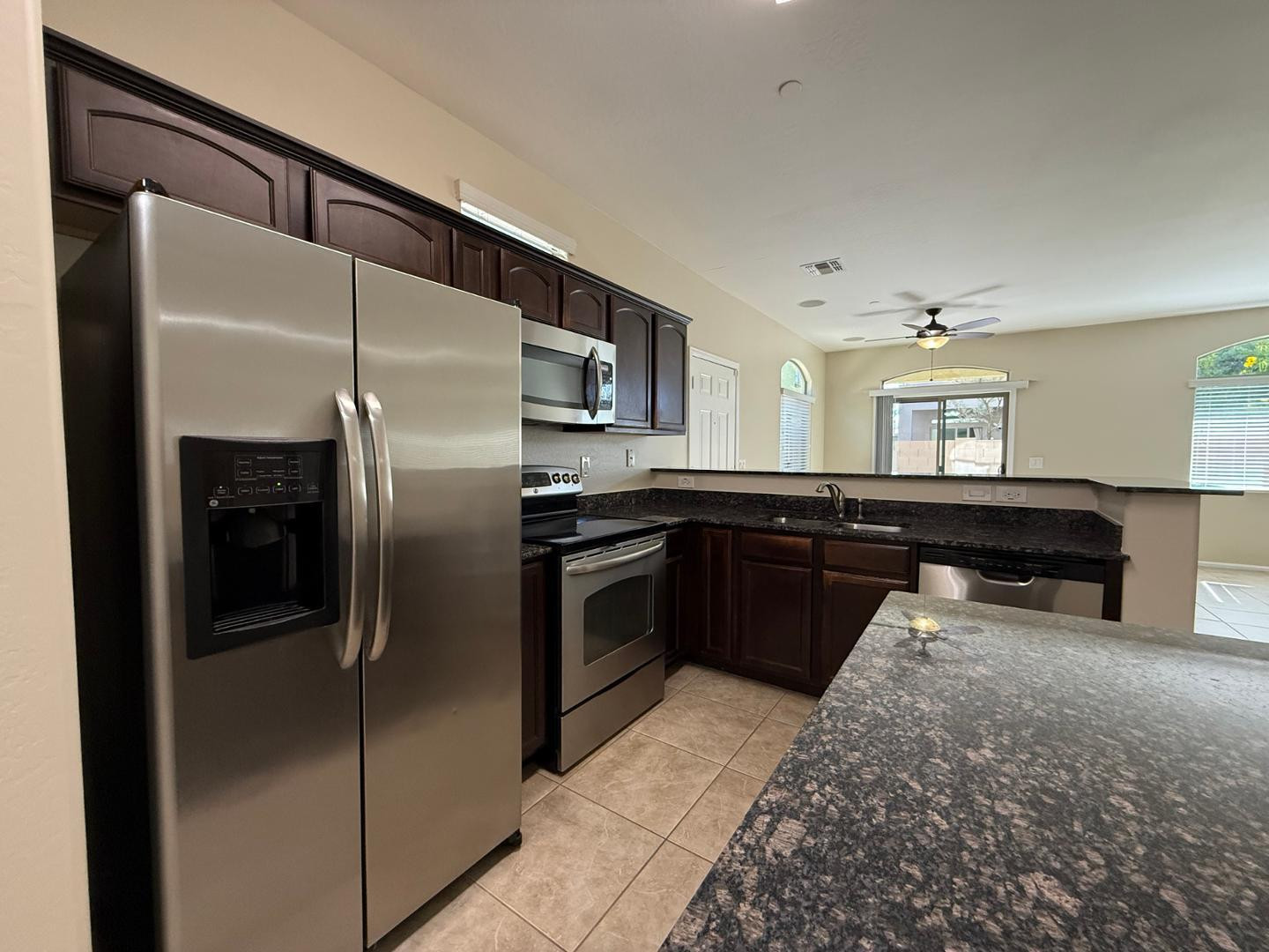 2725 East Mine Creek Road, Unit 1151 Phoenix, AZ 85024 - Photo 8 of 31 a kitchen with stainless steel appliances granite countertop a refrigerator and a sink