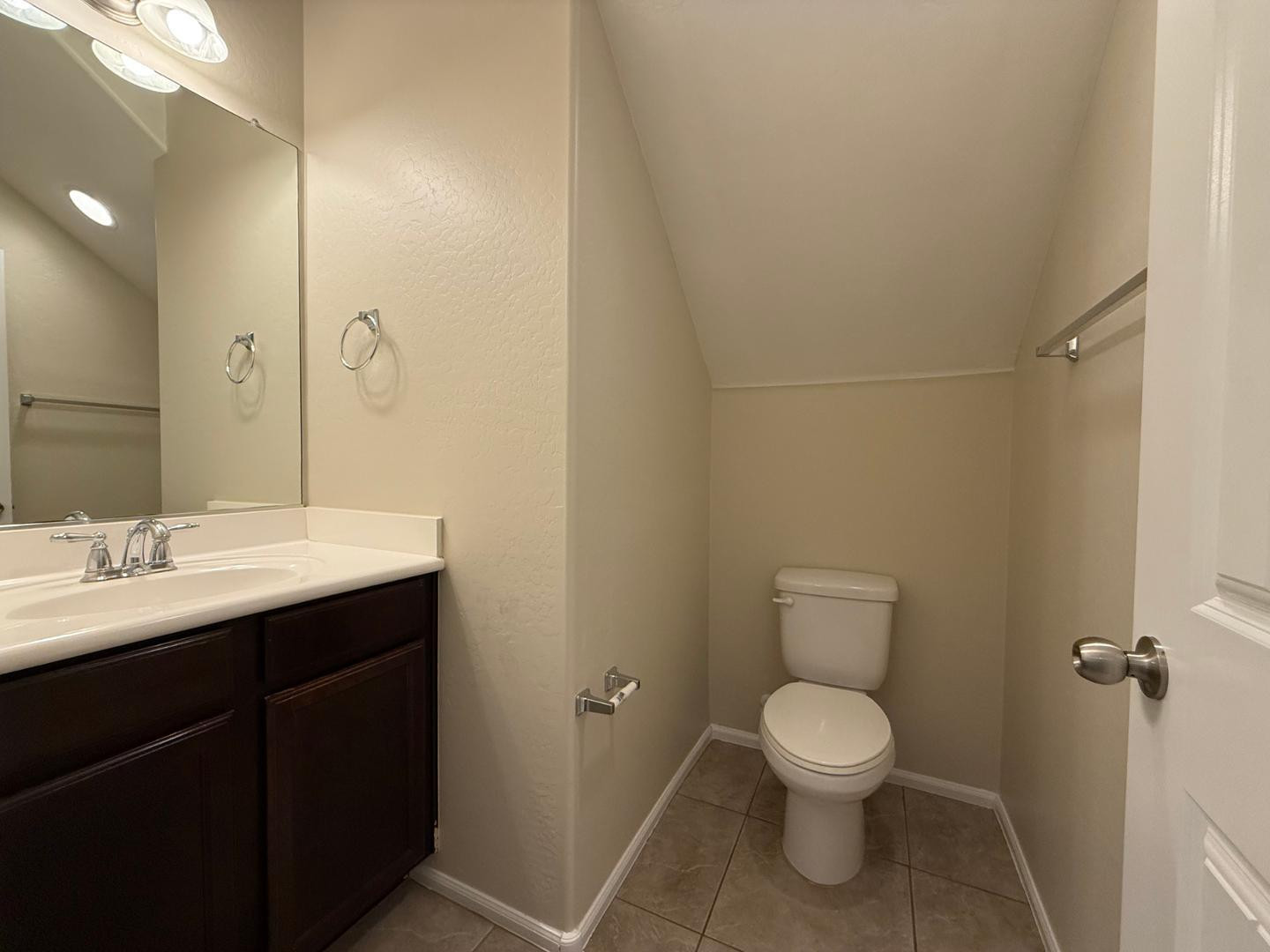 2725 East Mine Creek Road, Unit 1151 Phoenix, AZ 85024 - Photo 9 of 31 a bathroom with a toilet sink and mirror