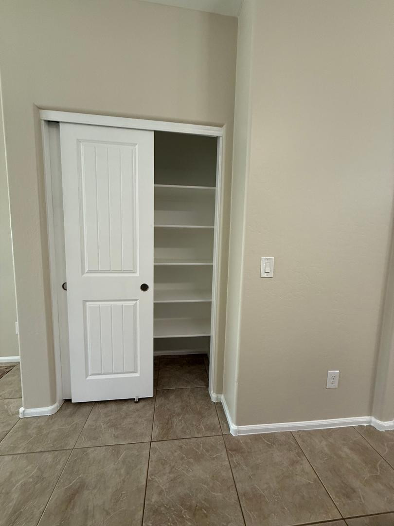 2725 East Mine Creek Road, Unit 1151 Phoenix, AZ 85024 - Photo 10 of 31 a view of room with walk in closet and racks